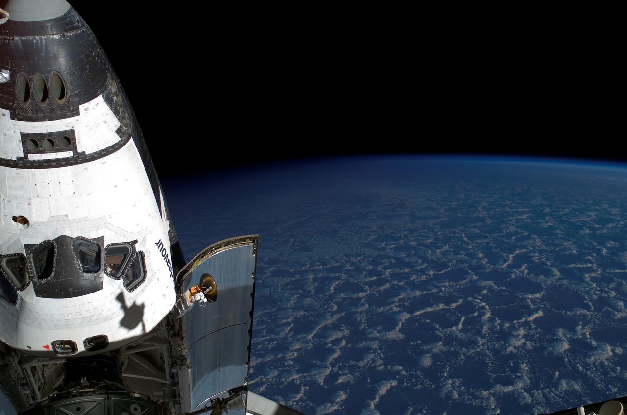 ISS015-E-21944 (11 Aug. 2007) --- Backdropped by the blackness of space and Earth's horizon, the Space Shuttle Endeavour, docked to the Pressurized Mating Adapter (PMA-2) on the International Space Station, is featured in this photograph taken by a crewmember during the mission's first planned session of extravehicular activity (EVA).