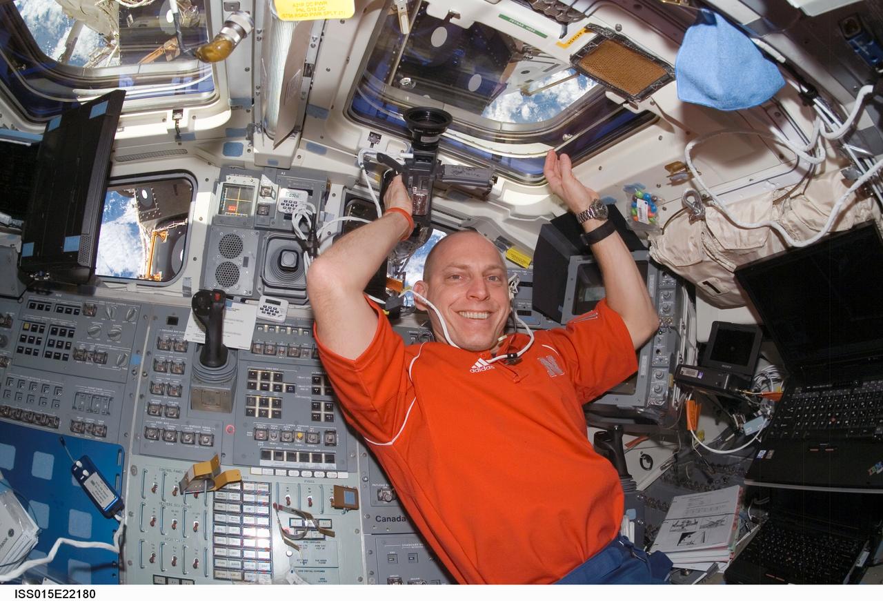ISS015-E-22180 (12 Aug. 2007) --- Astronaut Clay Anderson, Expedition 15 flight engineer, pauses for a photo while using a camera near the aft flight deck of Space Shuttle Endeavour while docked with the International Space Station.