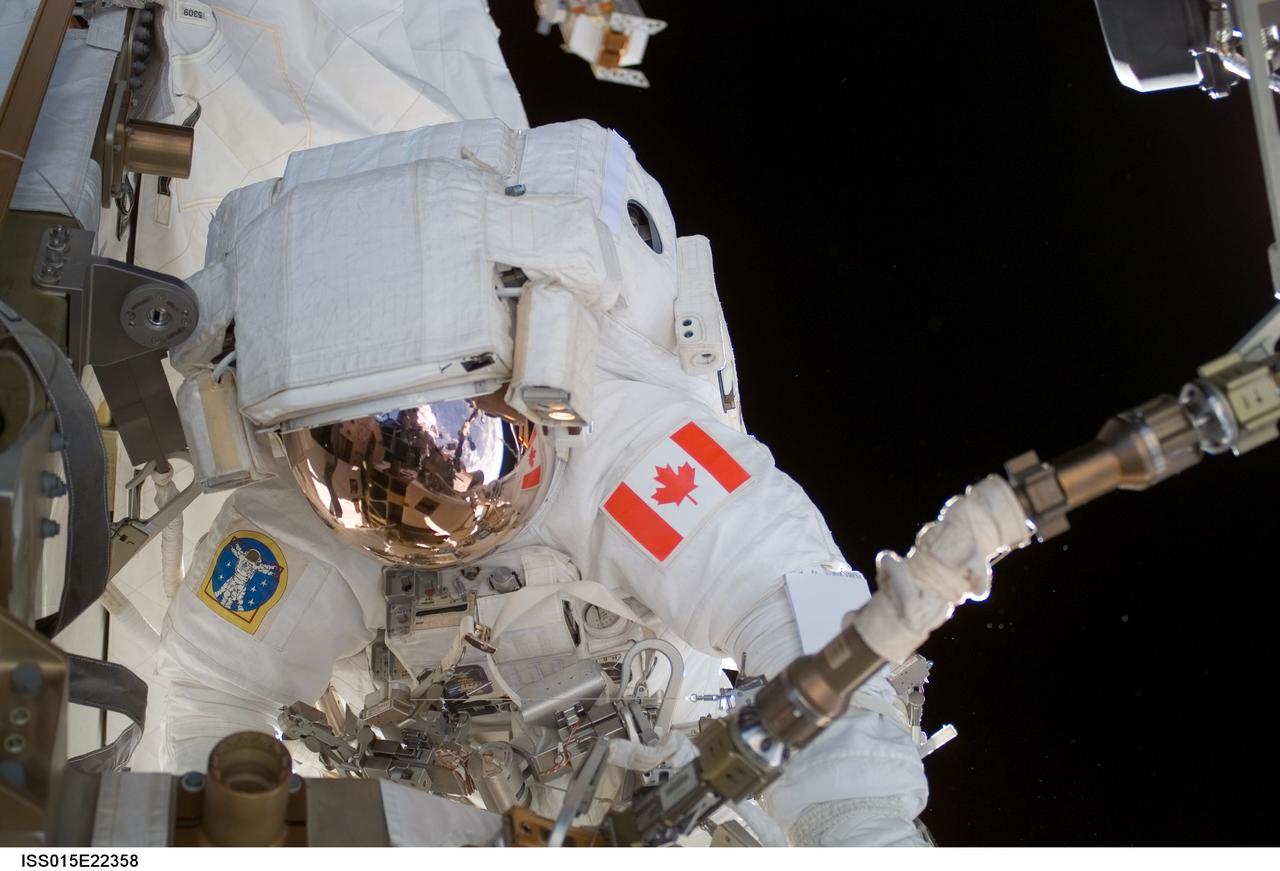 ISS015-E-22358 (13 Aug. 2007) --- Astronaut Dave Williams, STS-118 mission specialist representing the Canadian Space Agency, participates in the mission's second planned session of extravehicular activity (EVA) as construction and maintenance continue on the International Space Station. During the 6-hour, 28-minute spacewalk Williams and astronaut Rick Mastracchio (out of frame), mission specialist, removed a faulty control moment gyroscope (CMG-3) and installed a new CMG into the station's Z1 truss. The failed CMG will remain at its temporary stowage location on the station's exterior until it is returned to Earth on a later shuttle mission. The new gyroscope is one of four CMGs that are used to control the station's attitude in orbit.
