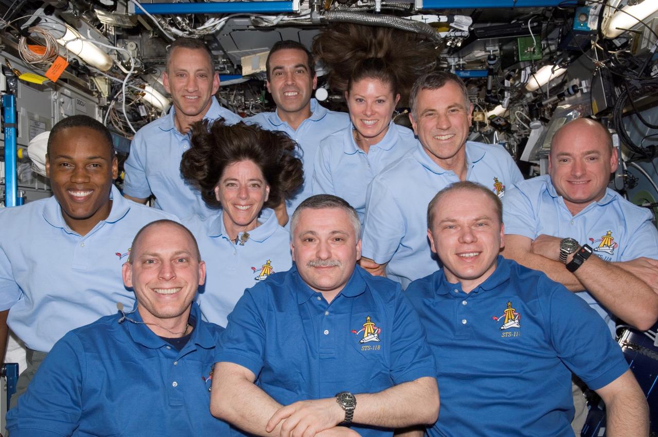 ISS015-E-23031 (17 Aug. 2007) --- The Expedition 15 and STS-118 crewmembers assemble in the Destiny laboratory on the International Space Station to greet and answer questions from news media representatives on the ground. ISS crewmembers on the front row, from the left: astronaut Clayton C. Anderson, flight engineer; along with cosmonauts Fyodor Yurchikhin, commander; and Oleg Kotov, flight engineer, both with Russia's Federal Space Agency. STS-118 crewmembers on the middle row, from the left: astronauts Alvin Drew, Barbara R. Morgan and the Canadian Space Agency's Dave Williams, all mission specialists, along with Scott Kelly, commander. STS-118 crewmembers on the back row, from the left: astronaut Charlie Hobaugh, pilot, along with astronauts Rick Mastracchio and Tracy Caldwell, both mission specialists.