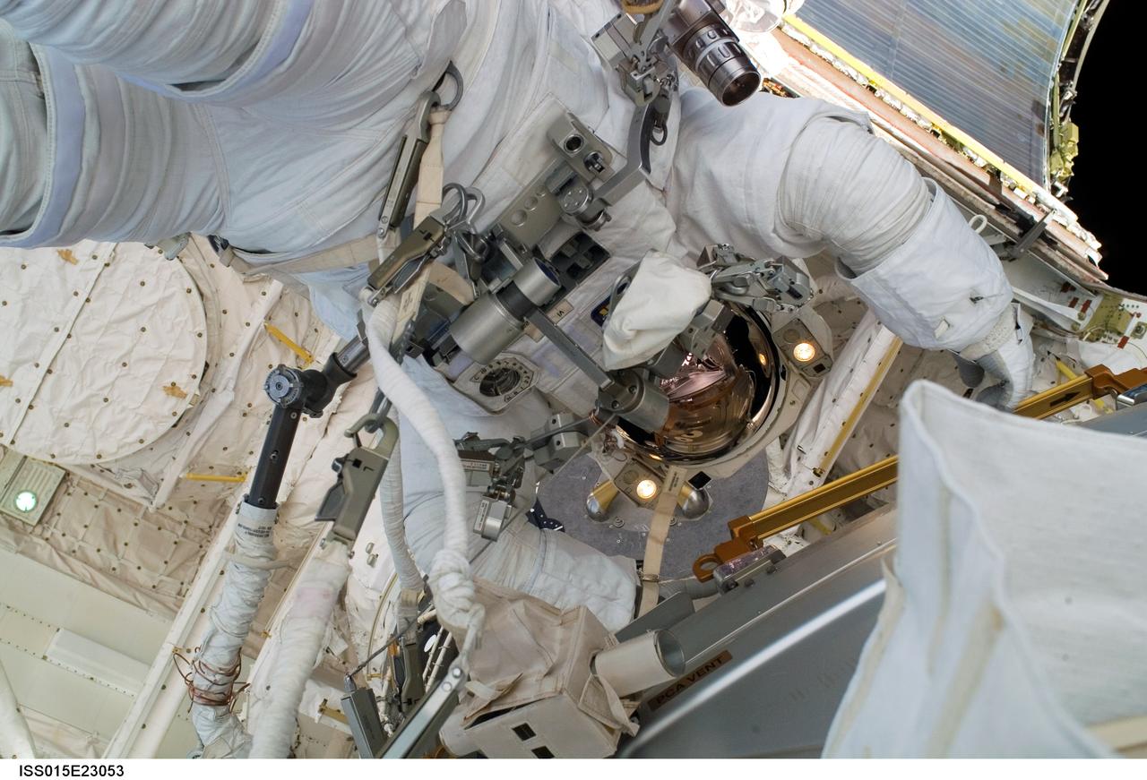 ISS015-E-23053 (18 Aug. 2007) --- Astronaut Dave Williams, STS-118 mission specialist representing the Canadian Space Agency, participates in the mission's fourth and final session of extravehicular activity (EVA) as construction and maintenance continue on the International Space Station. During the 5-hour spacewalk, Williams and astronaut Clay Anderson (out of frame), Expedition 15 flight engineer, installed the External Wireless Instrumentation System antenna, attached a stand for the shuttle's robotic arm extension boom and retrieved the two Materials International Space Station Experiments (MISSE) to be brought back on the shuttle.