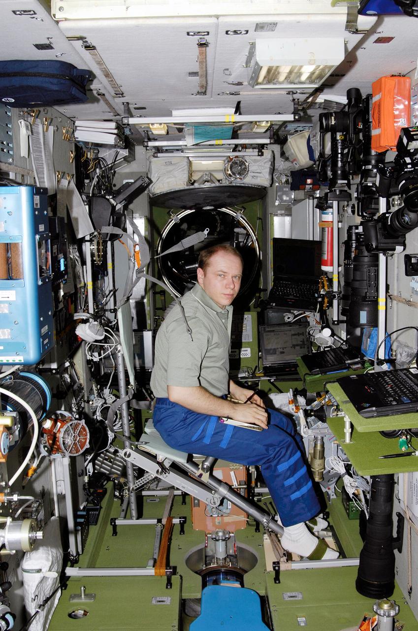 ISS015-E-23899 (24 Aug. 2007) --- Cosmonaut Oleg V. Kotov, Expedition 15 flight engineer representing Russia's Federal Space Agency, works in the Zvezda Service Module of the International Space Station. Kotov occupied an "operator seat", which is a portable chair that replicates a crewmember's anatomical back curvature.
