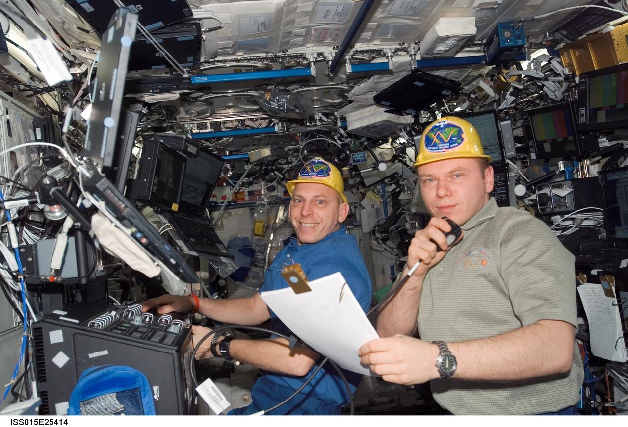 ISS015-E-25414 (30 Aug. 2007) --- Astronaut Clay Anderson (left), Expedition 15 flight engineer, works the controls of the station's robotic arm, Canadarm2; while cosmonaut Oleg V. Kotov, flight engineer representing Russia's Federal Space Agency, uses a communication system in the Destiny laboratory of the International Space Station during Pressurized Mating Adapter-3 (PMA-3) transfer operations. Using the Canadarm2, the PMA-3 was undocked from the Unity node's left side at 7:18 a.m. (CDT) and docked to Unity's lower port at 8:07 a.m. to prepare for the arrival of Node 2, the Harmony module, on the STS-120 flight of Space Shuttle Discovery in October 2007.