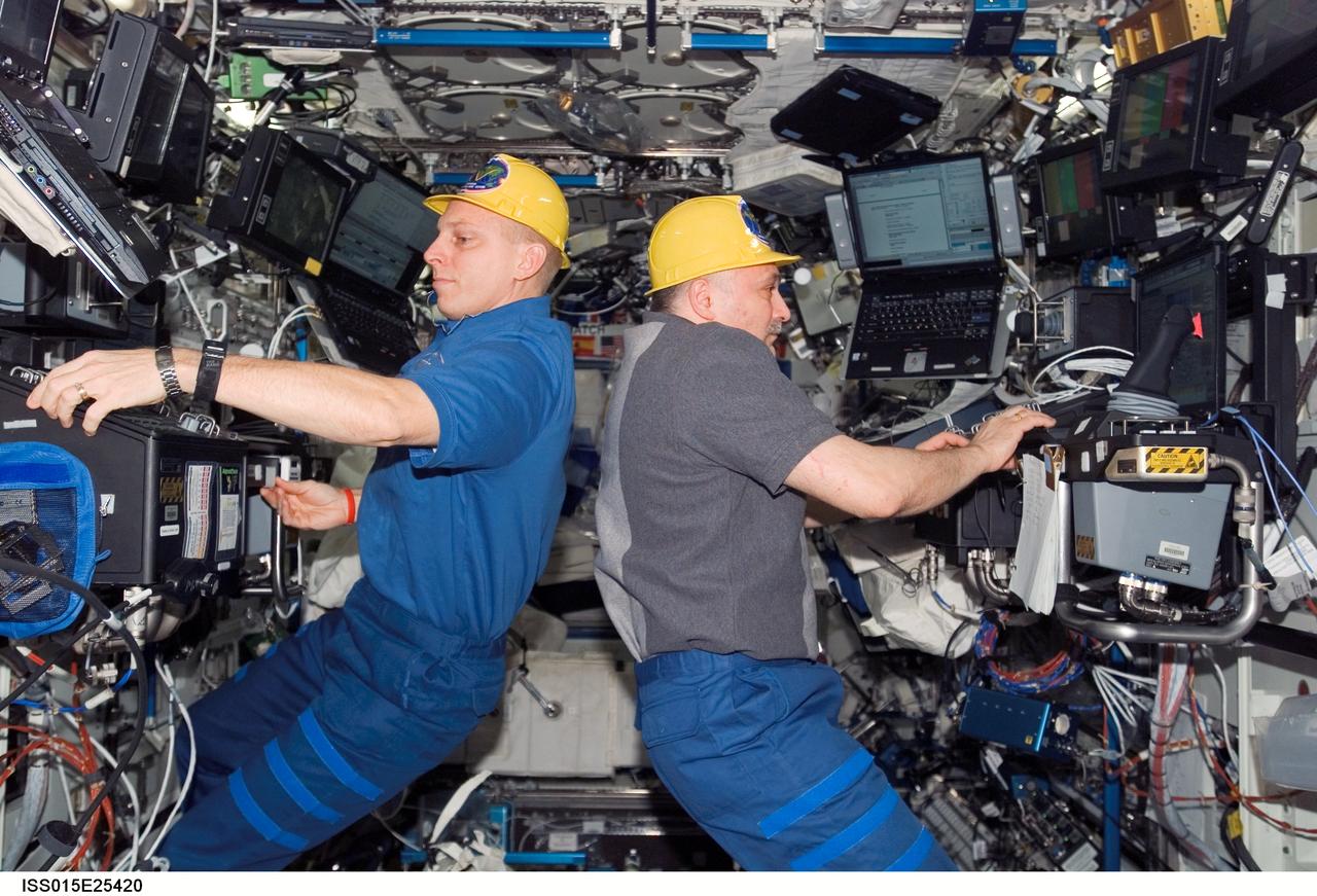 ISS015-E-25420 (30 Aug. 2007) --- Astronaut Clay Anderson (left), Expedition 15 flight engineer, works the controls of the station's robotic arm, Canadarm2; while cosmonaut Fyodor N. Yurchikhin, commander representing Russia's Federal Space Agency, works with docking systems in the Destiny laboratory of the International Space Station during Pressurized Mating Adapter-3 (PMA-3) transfer operations. Using the Canadarm2, the PMA-3 was undocked from the Unity node's left side at 7:18 a.m. (CDT) and docked to Unity's lower port at 8:07 a.m. to prepare for the arrival of Node 2, the Harmony module, on the STS-120 flight of Space Shuttle Discovery in October 2007.