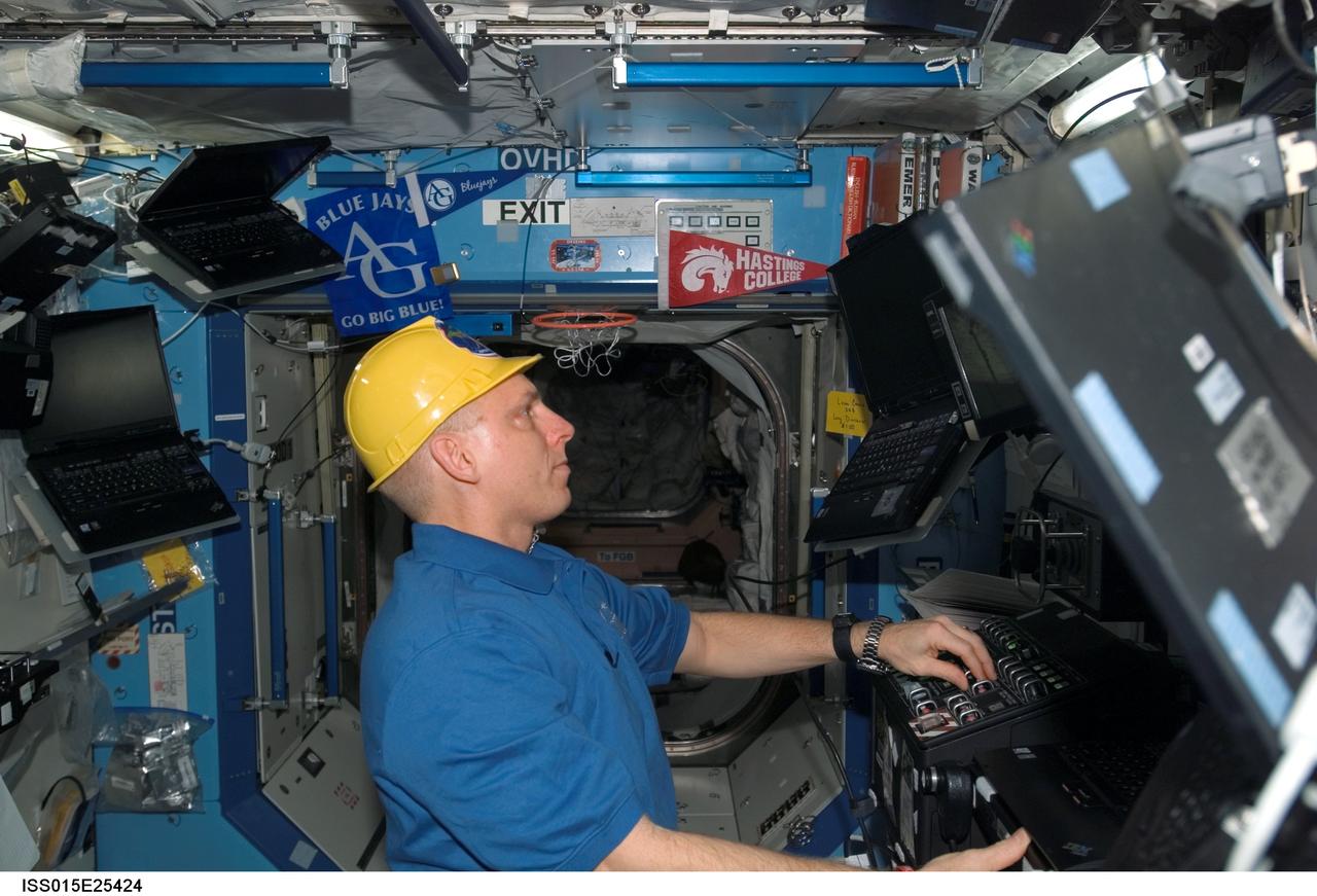 ISS015-E-25424 (30 Aug. 2007) --- Astronaut Clay Anderson, Expedition 15 flight engineer, works the controls of the station's robotic arm, Canadarm2, in the Destiny laboratory of the International Space Station during Pressurized Mating Adapter-3 (PMA-3) transfer operations. Using the Canadarm2, the PMA-3 was undocked from the Unity node's left side at 7:18 a.m. (CDT) and docked to Unity's lower port at 8:07 a.m. to prepare for the arrival of Node 2, the Harmony module, on the STS-120 flight of Space Shuttle Discovery in October 2007.