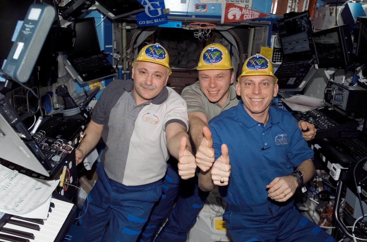 ISS015-E-25439 (30 Aug. 2007) --- Cosmonauts Fyodor N. Yurchikhin (left) and Oleg V. Kotov, Expedition 15 commander and flight engineer, respectively, both representing Russia's Federal Space Agency; along with astronaut Clay Anderson, flight engineer, give a "thumbs-up" signal at the conclusion of Pressurized Mating Adapter-3 (PMA-3) transfer operations in the Destiny laboratory of the International Space Station. Using the station's robotic arm, Canadarm2, the PMA-3 was undocked from the Unity node's left side at 7:18 a.m. (CDT) and docked to Unity's lower port at 8:07 a.m. to prepare for the arrival of Node 2, the Harmony module, on the STS-120 flight of Space Shuttle Discovery in October 2007.