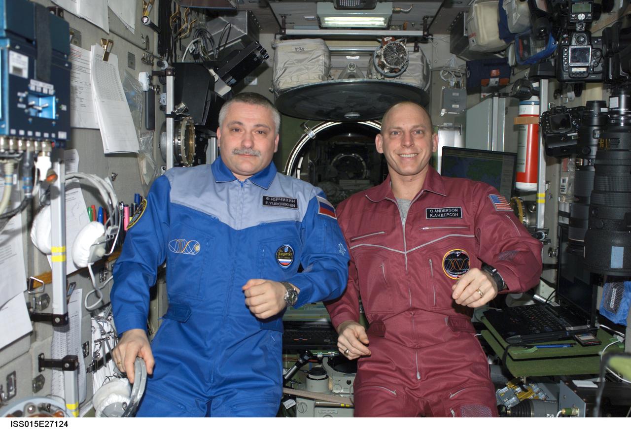 ISS015-E-27124 (4 Sept. 2007) --- Cosmonaut Fyodor N. Yurchikhin (left), Expedition 15 commander representing Russia's Federal Space Agency, and NASA astronaut Clay Anderson, flight engineer, pose for a photo in the Zvezda Service Module of the International Space Station.