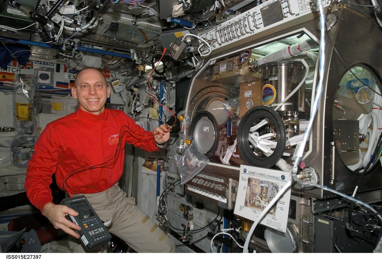 ISS015-E-27397 (8 Sept. 2007) --- NASA astronaut Clay Anderson, Expedition 15 flight engineer, pauses for a photo while working on the Smoke and Aerosol Measurement Experiment (SAME) hardware located in the Microgravity Science Glovebox (MSG) in the Destiny laboratory of the International Space Station. SAME will measure the smoke properties, or particle size distribution, of typical particles that are produced from different materials that can be found onboard station and other spacecrafts. SAME aims to test the performance of ionization smoke detectors and evaluate the performance of the photoelectric smoke detectors. The data will be used to develop a model that can predict smoke droplet growth that will be used to evaluate future smoke detection devices.