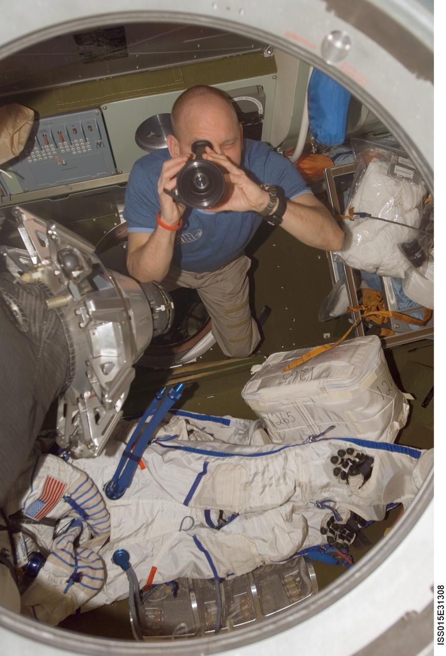 ISS015-E-31308 (27 Sept. 2007) --- Astronaut Clay Anderson, Expedition 15 flight engineer, uses a camera in the Soyuz TMA-10 spacecraft docked to the Zarya module nadir port of the International Space Station.