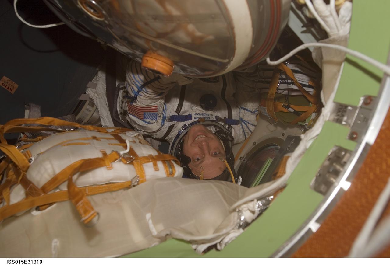 ISS015-E-31319 (27 Sept. 2007) --- Attired in a Russian Sokol launch and entry suit, astronaut Clay Anderson, Expedition 15 flight engineer, is photographed in the Soyuz TMA-10 spacecraft docked to the International Space Station. The Expedition 15 crew undocked the Soyuz spacecraft from the nadir port of the Zarya module at 2:20 p.m. (CDT) and flew a short distance to the aft port of the Zvezda Service Module. Redocking occurred at 2:45 p.m. (CDT). The move was in preparation for the arrival of the new Soyuz TMA-11 capsule on Oct. 12, carrying the Expedition 16 crew and a Malaysian spaceflight participant.