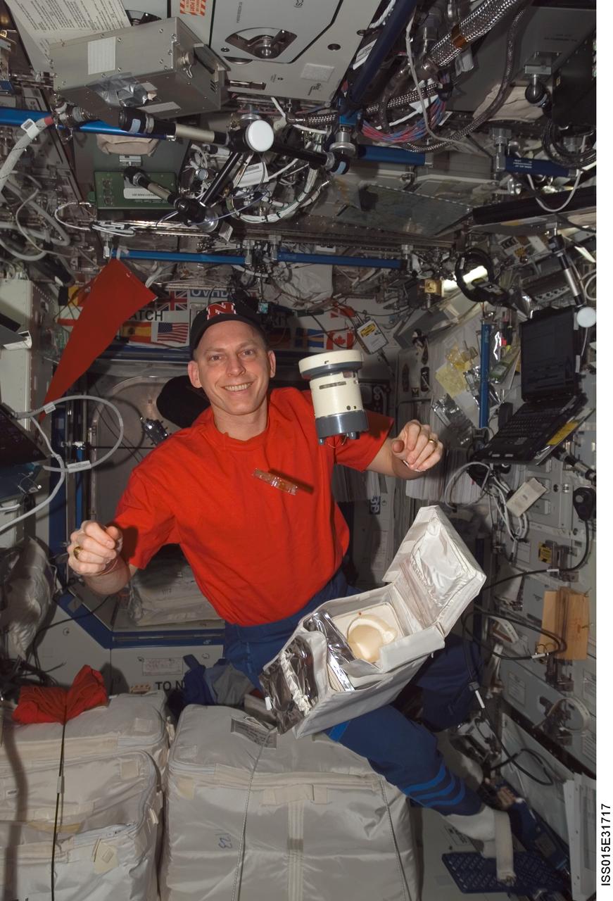 ISS015-E-31717 (3 Oct. 2007) --- Astronaut Clay Anderson, Expedition 15 flight engineer, poses with a microbial air sampler (MAS) and petri dish in the Destiny laboratory of the International Space Station.