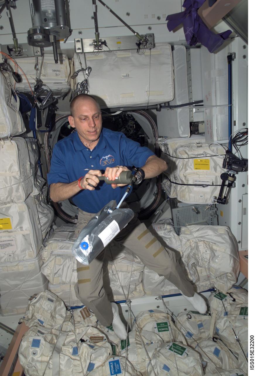 ISS015-E-32200 (6 Oct. 2007) --- Astronaut Clay Anderson, Expedition 15 flight engineer, uses an air sample pump and 2.5 liter gas sample bag to gather and analyze air samples for the Analyzing Interferometer for Ambient Air (ANITA) experiment in the Unity node of the International Space Station.