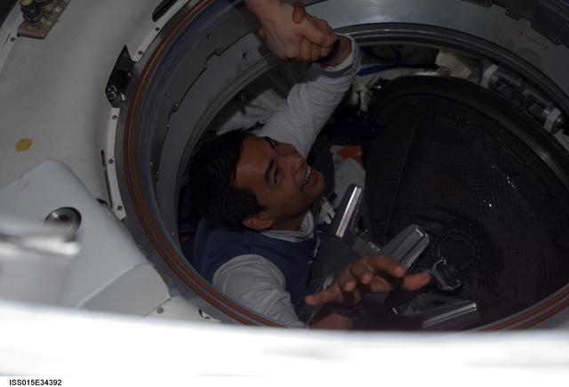 NASA image: View of Spaceflight Participant Shukor exiting the docked Soyuz