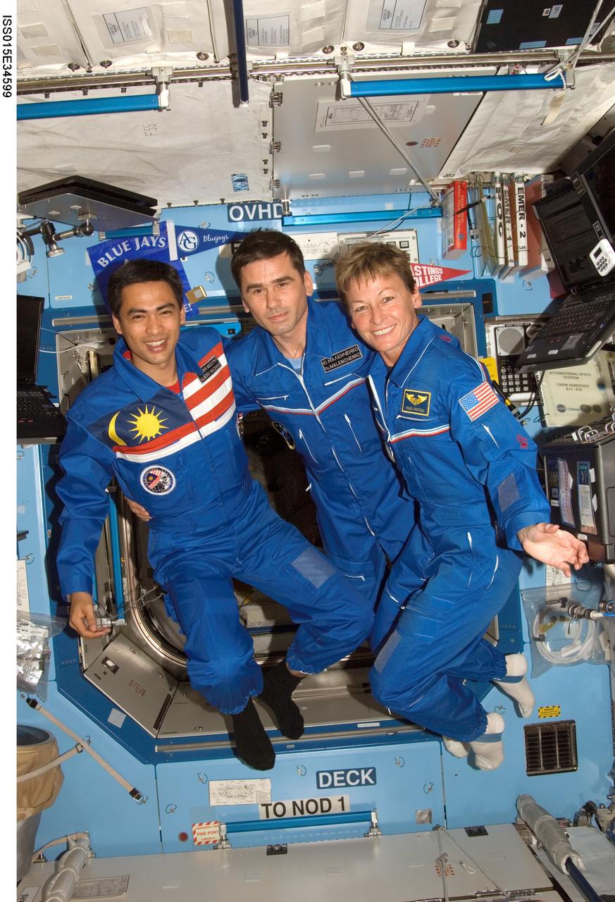 ISS015-E-34599 (16 Oct. 2007) --- NASA astronaut Peggy A. Whitson (right), Expedition 16 commander; cosmonaut Yuri I. Malenchenko (center), Soyuz commander and flight engineer representing Russia's Federal Space Agency; and Malaysian spaceflight participant Sheikh Muszaphar Shukor pose for a photo in the Destiny laboratory of the International Space Station.