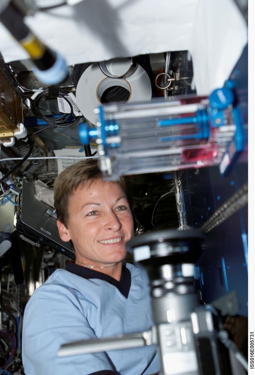 ISS016-E-005731 (22 Oct. 2007) --- NASA astronaut Peggy A. Whitson, Expedition 16 commander, prepares the Capillary Flow Experiment (CFE) Vane Gap-1 for video documentation. The CFE is positioned on the Maintenance Work Area in the Destiny laboratory of the International Space Station. CFE observes the flow of fluid, in particular capillary phenomena, in microgravity.