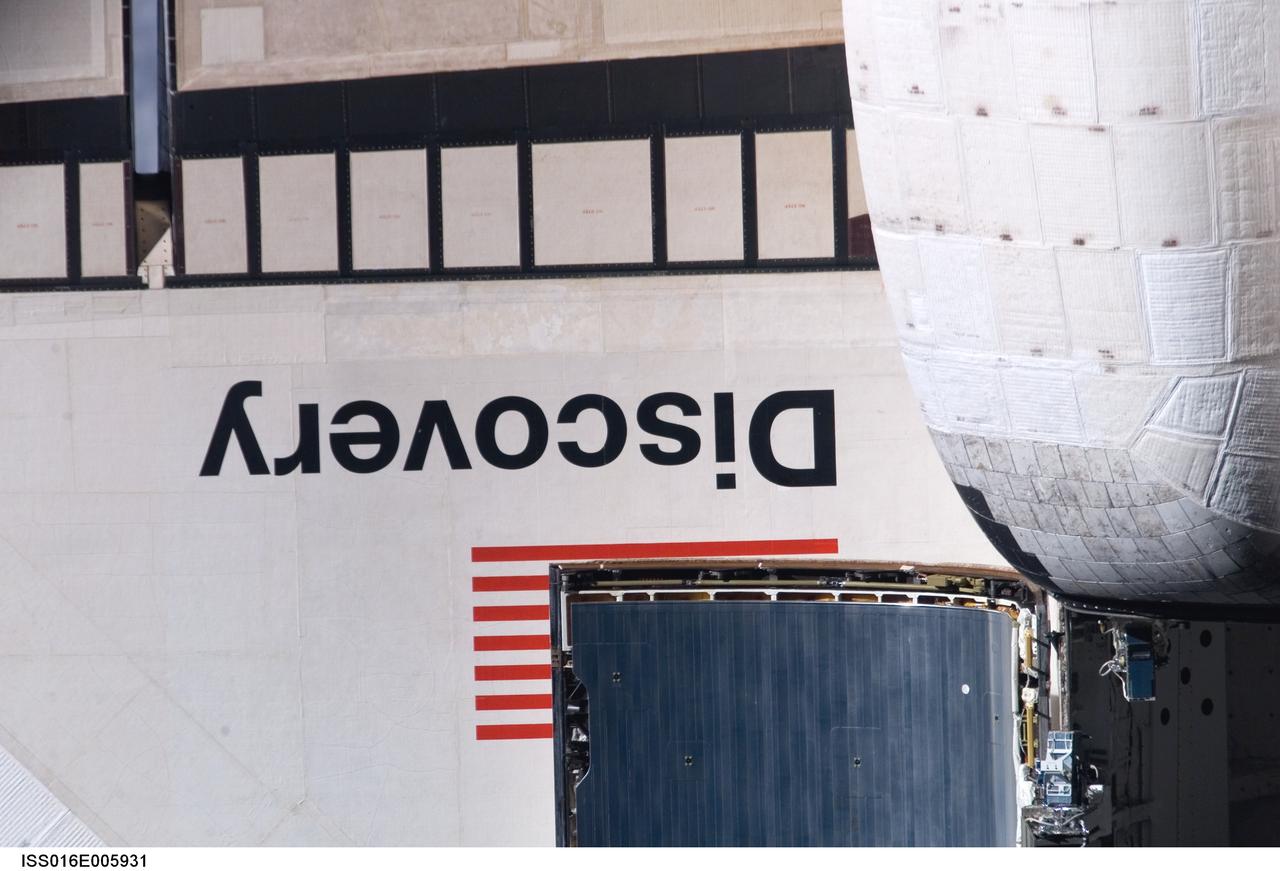 ISS016-E-005931 (25 Oct. 2007) --- A close-up view of Space Shuttle Discovery's wing section is provided by this image photographed by an Expedition 16 crewmember during a backflip maneuver performed by the approaching visitors (STS-120) to the International Space Station. Also visible are partial views of the orbital maneuvering system (OMS) pods and a portion of the payload bay door panels.