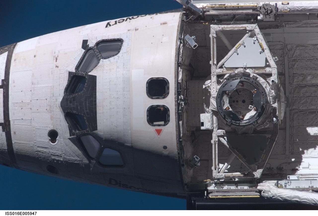 ISS016-E-005947 (25 Oct. 2007) --- Space Shuttle Discovery's crew cabin and docking apparatus in the forward payload bay are featured in this close-up image photographed by an Expedition 16 crewmember during a backflip maneuver performed by the approaching visitors (STS-120) to the International Space Station.