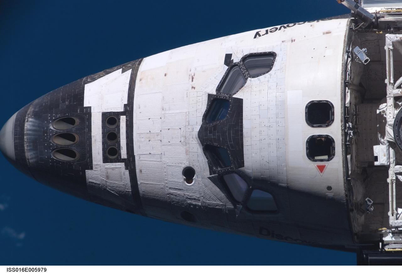 ISS016-E-005979 (25 Oct. 2007) --- Space Shuttle Discovery's crew cabin is featured in this close-up image photographed by an Expedition 16 crewmember during a backflip maneuver performed by the approaching visitors (STS-120) to the International Space Station.