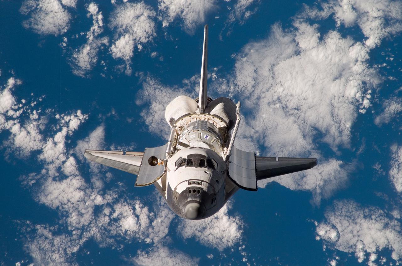ISS016-E-006297 (25 Oct. 2007) --- Backdropped by a blue and white Earth, Space Shuttle Discovery approaches the International Space Station during STS-120 rendezvous and docking operations. Docking occurred at 7:40 a.m. (CDT) on Oct. 25, 2007. The Harmony node is visible in Discovery's cargo bay.