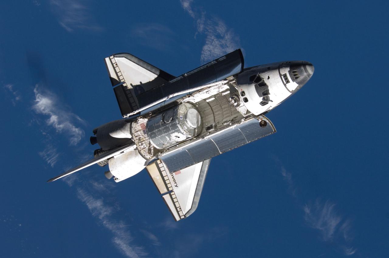 ISS016-E-006327 (25 Oct. 2007) --- Backdropped by a blue and white Earth, Space Shuttle Discovery approaches the International Space Station during STS-120 rendezvous and docking operations. Docking occurred at 7:40 a.m. (CDT) on Oct. 25, 2007. The Harmony node is visible in Discovery's cargo bay.