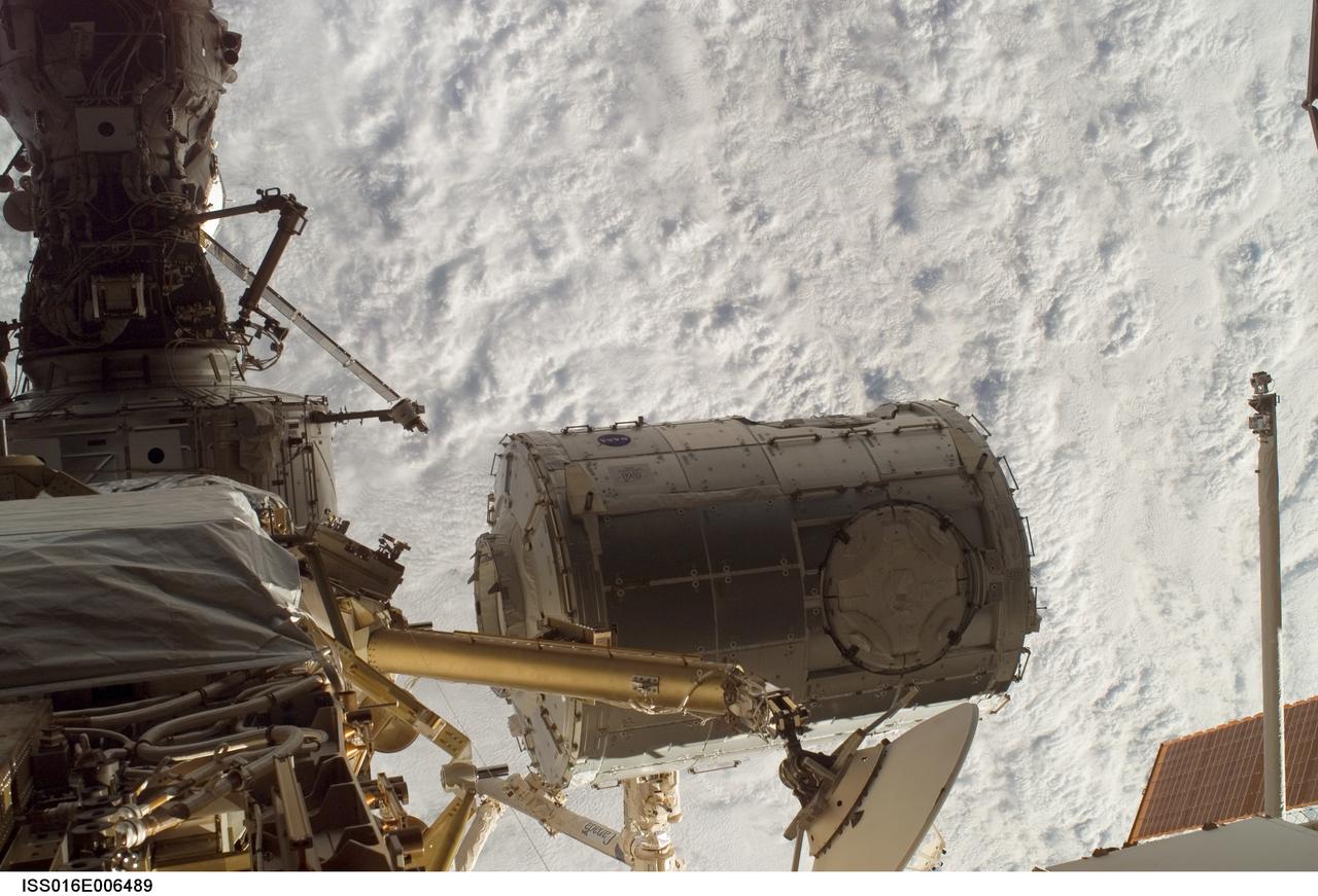 ISS016-E-006489 (26 Oct. 2007) --- In the grasp of the station's Canadarm2, the Harmony module (center) is moved from its stowage position in the cargo bay of the Space Shuttle Discovery (STS-120) to its temporary location on the International Space Station.