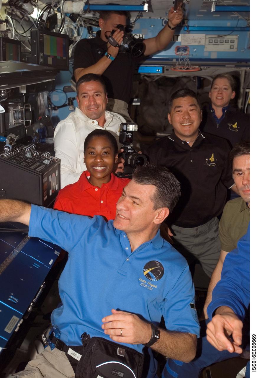 ISS016-E-006669 (25 Oct. 2007) --- Expedition 16 and STS-120 crewmembers gather in the Destiny laboratory of the International Space Station shortly after Space Shuttle Discovery docked with the station. Pictured (clockwise) are European Space Agency (ESA) astronaut Paolo Nespoli (foreground), NASA astronauts Stephanie Wilson, both STS-120 mission specialists; George Zamka, STS-120 pilot; Doug Wheelock, mission specialist; Pam Melroy, STS-120 commander; Daniel Tani, Expedition 16 flight engineer; and cosmonaut Yuri I. Malenchenko, flight engineer representing Russia's Federal Space Agency.