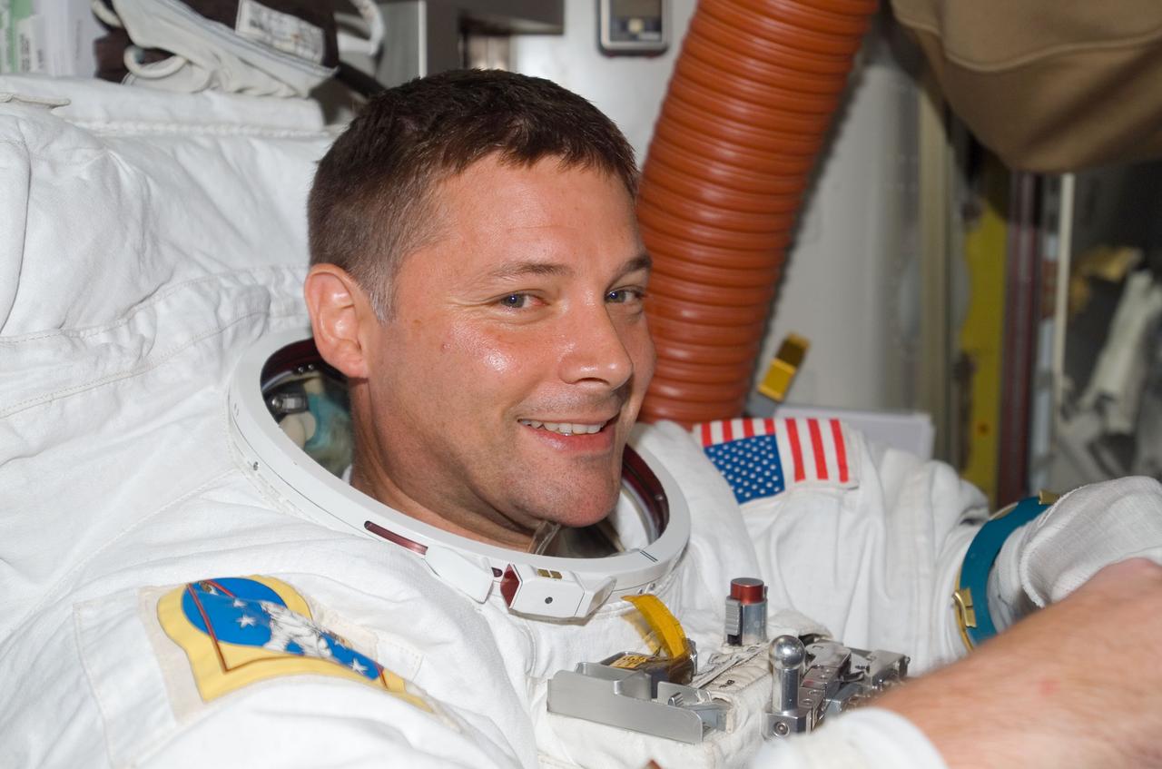 ISS016-E-006779 (26 Oct. 2007) --- Attired in his Extravehicular Mobility Unit (EMU) spacesuit, astronaut Doug Wheelock, STS-120 mission specialist, is pictured in the Quest Airlock of the International Space Station as the mission's first spacewalk draws to a close.