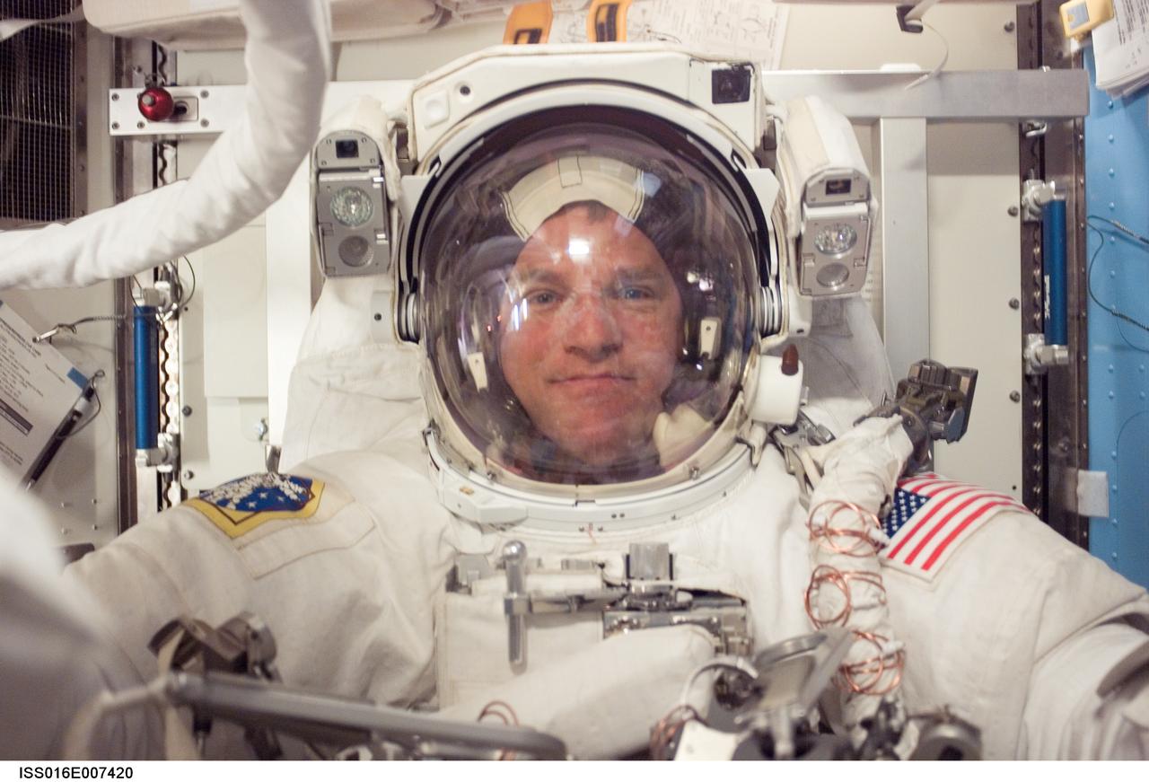 ISS016-E-007420 (30 Oct. 2007) --- Attired in his Extravehicular Mobility Unit (EMU) spacesuit, astronaut Scott Parazynski, STS-120 mission specialist, prepares for the mission's third session of extravehicular activity (EVA) in the Quest Airlock of the International Space Station while Space Shuttle Discovery is docked with the station.