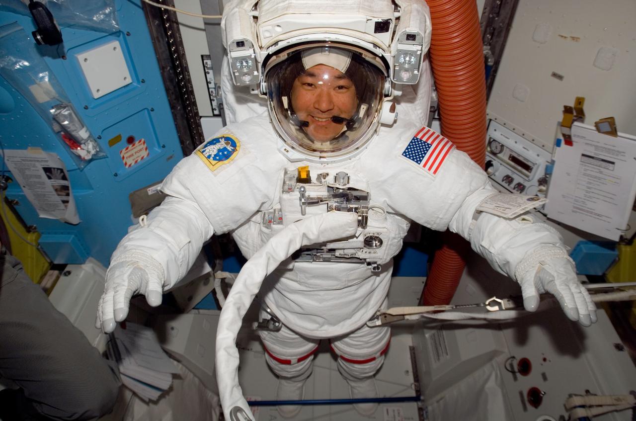 ISS016-E-007830 (28 Oct. 2007) --- Attired in his Extravehicular Mobility Unit (EMU) spacesuit, astronaut Daniel Tani, Expedition 16 flight engineer, prepares for the mission's second session of extravehicular activity (EVA) in the Quest Airlock of the International Space Station while Space Shuttle Discovery is docked with the station.