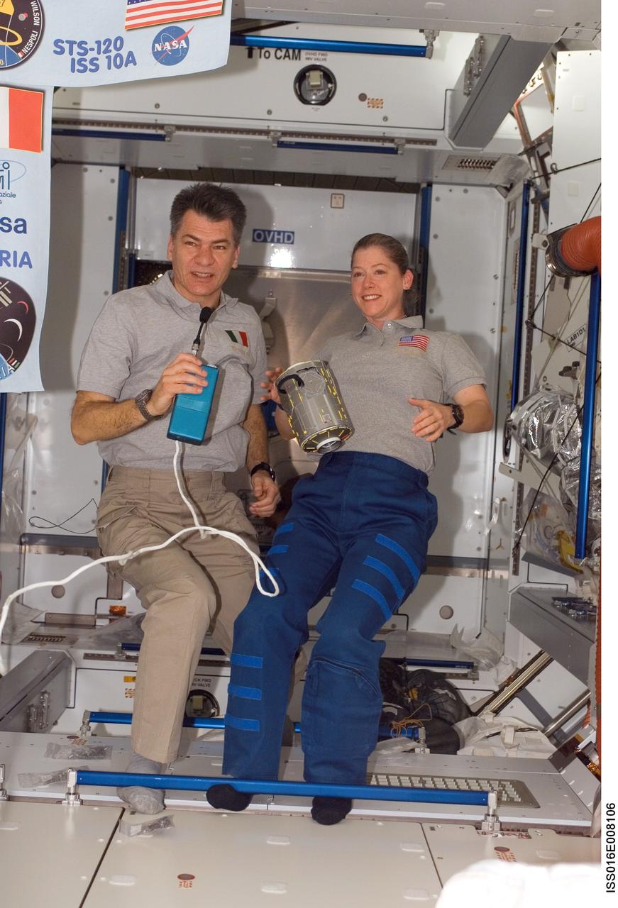 ISS016-E-008106 (31 Oct. 2007) --- Astronauts Pam Melroy, STS-120 commander, and European Space Agency's (ESA) Paolo Nespoli, mission specialist, are pictured in the Harmony node of the International Space Station during a congratulatory phone call from the president of Italy. A module of Harmony floats freely in the foreground.