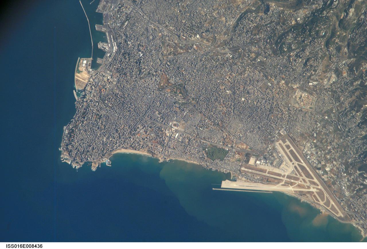 ISS016-E-008436 (26 Oct. 2007) --- Beirut Metropolitan Area, Lebanon is featured in this image photographed by an Expedition 16 crewmember on the International Space Station. The capital of Lebanon, Beirut is located along the southeastern shoreline of the Mediterranean Sea. According to geologists, the metropolitan area is built on a small peninsula composed mainly of sedimentary rock deposited over the past 100 million years or so. The growth of the city eastwards is bounded by foothills of the more mountainous interior of Lebanon (sparsely settled greenish brown region visible at upper right). While this sedimentary platform is stable, the country of Lebanon is located along a major transform fault zone, or region where the African and Arabian tectonic plates are moving laterally in relation to (and against) each other. This active tectonism creates an earthquake hazard for the country. The Roum Fault, one of the fault strands that is part of the transform boundary, is located directly to the south of the Beirut metropolitan area. Other distinctive features visible in this image include the Rafic Hariri Airport at lower right, the city sports arena at center, and several areas of green and open space (such a large golf course at center). Also visible in the image are several plumes of sediment along the coastline -- the most striking of which are located near the airport. The general lack of vegetation in the airport may promote higher degrees of soil transport by surface water runoff or wind.