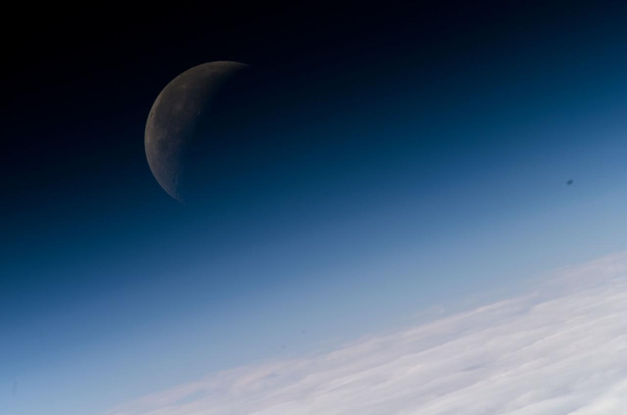 ISS016-E-008867 (3 Nov. 2007) --- A gibbous moon is visible in this view of Earth's horizon and atmosphere, photographed by an Expedition 16 crewmember on the International Space Station while Space Shuttle Discovery (STS-120) is docked with the station.