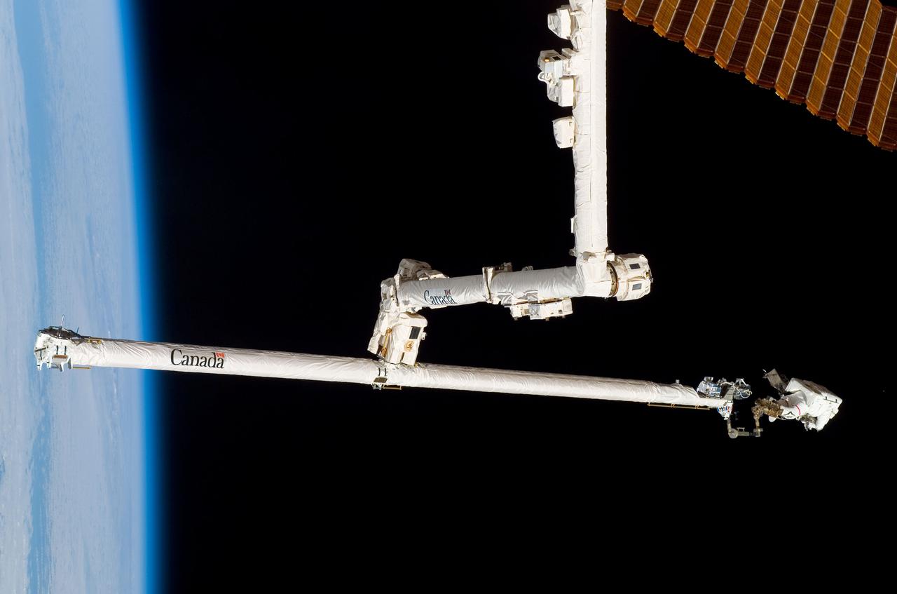 ISS016-E-009135 (3 Nov. 2007) --- While anchored to a foot restraint on the end of the Orbiter Boom Sensor System (OBSS), astronaut Scott Parazynski, STS-120 mission specialist, participates in the mission's fourth session of extravehicular activity (EVA) while Space Shuttle Discovery is docked with the International Space Station. During the 7-hour, 19-minute spacewalk, Parazynski cut a snagged wire and installed homemade stabilizers designed to strengthen the damaged solar array's structure and stability in the vicinity of the damage. Astronaut Doug Wheelock (out of frame), mission specialist, assisted from the truss by keeping an eye on the distance between Parazynski and the array. Once the repair was complete, flight controllers on the ground successfully completed the deployment of the array.