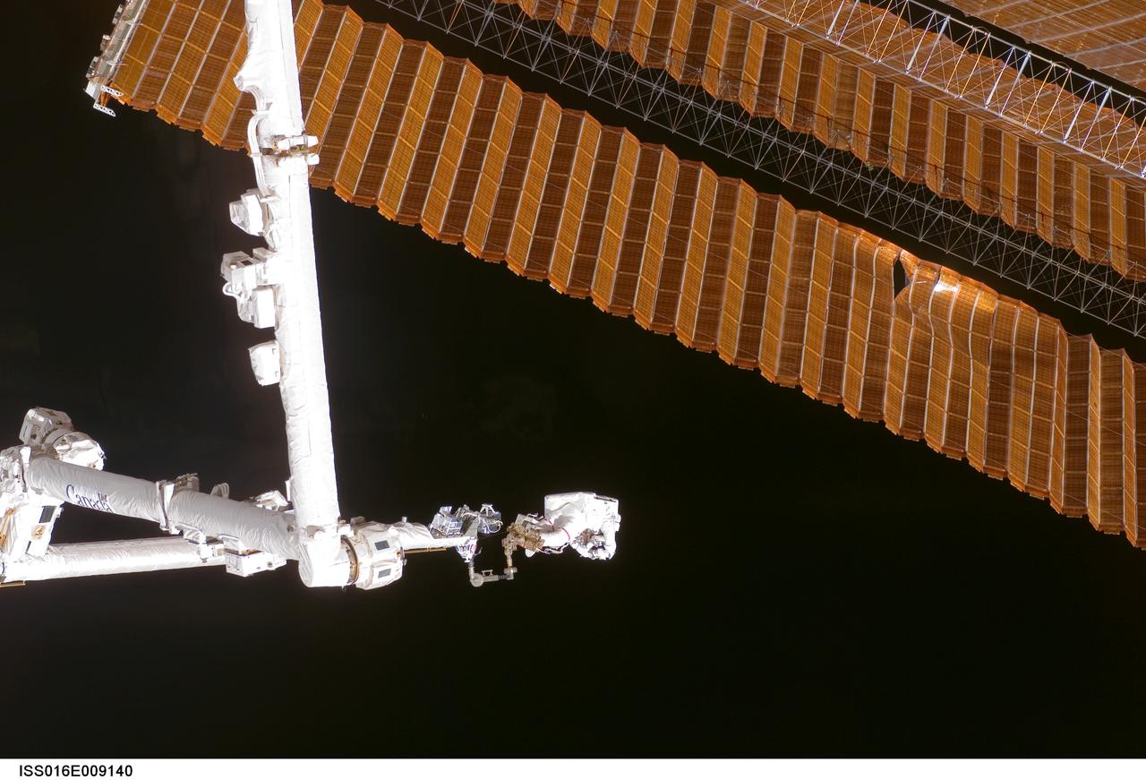 ISS016-E-009140 (3 Nov. 2007) --- While anchored to a foot restraint on the end of the Orbiter Boom Sensor System (OBSS), astronaut Scott Parazynski, STS-120 mission specialist, participates in the mission's fourth session of extravehicular activity (EVA) while Space Shuttle Discovery is docked with the International Space Station. During the 7-hour, 19-minute spacewalk, Parazynski cut a snagged wire and installed homemade stabilizers designed to strengthen the damaged solar array's structure and stability in the vicinity of the damage. Astronaut Doug Wheelock (out of frame), mission specialist, assisted from the truss by keeping an eye on the distance between Parazynski and the array. Once the repair was complete, flight controllers on the ground successfully completed the deployment of the array.