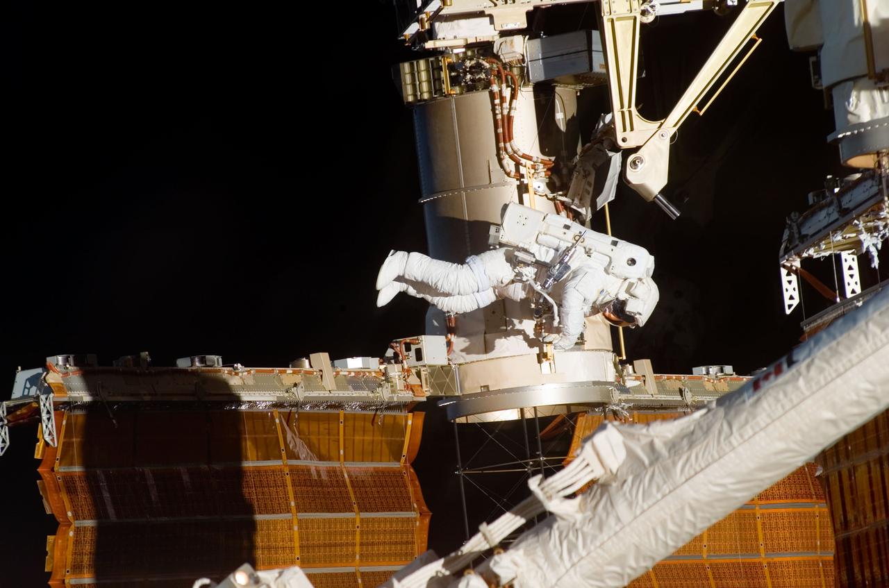 ISS016-E-009179 (3 Nov. 2007) --- Astronaut Doug Wheelock, STS-120 mission specialist, participates in the mission's fourth session of extravehicular activity (EVA) while Space Shuttle Discovery is docked with the International Space Station. During the 7-hour, 19-minute spacewalk, astronaut Scott Parazynski (out of frame), mission specialist, cut a snagged wire and installed homemade stabilizers designed to strengthen the damaged solar array's structure and stability in the vicinity of the damage. Wheelock assisted from the truss by keeping an eye on the distance between Parazynski and the array. Once the repair was complete, flight controllers on the ground successfully completed the deployment of the array.