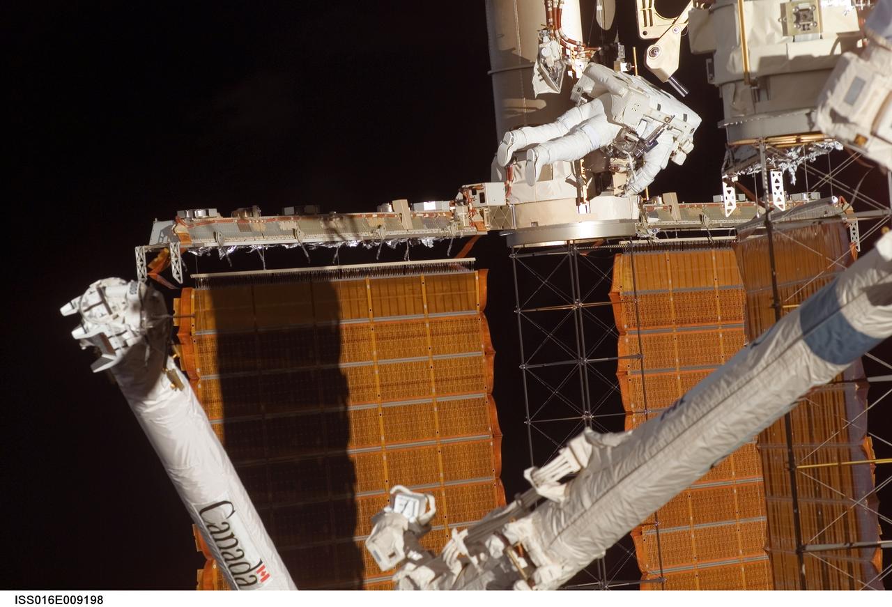 ISS016-E-009198 (3 Nov. 2007) --- Astronaut Doug Wheelock, STS-120 mission specialist, participates in the mission's fourth session of extravehicular activity (EVA) while Space Shuttle Discovery is docked with the International Space Station. During the 7-hour, 19-minute spacewalk, astronaut Scott Parazynski (out of frame), mission specialist, cut a snagged wire and installed homemade stabilizers designed to strengthen the damaged solar array's structure and stability in the vicinity of the damage. Wheelock assisted from the truss by keeping an eye on the distance between Parazynski and the array. Once the repair was complete, flight controllers on the ground successfully completed the deployment of the array.