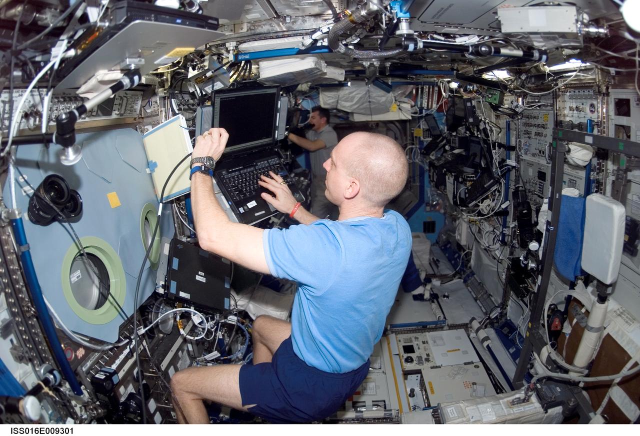 ISS016-E-009301 (4 Nov. 2007) --- Astronaut Clay Anderson, STS-120 mission specialist, uses a computer in the Destiny laboratory of the International Space Station while Space Shuttle Discovery is docked with the station.