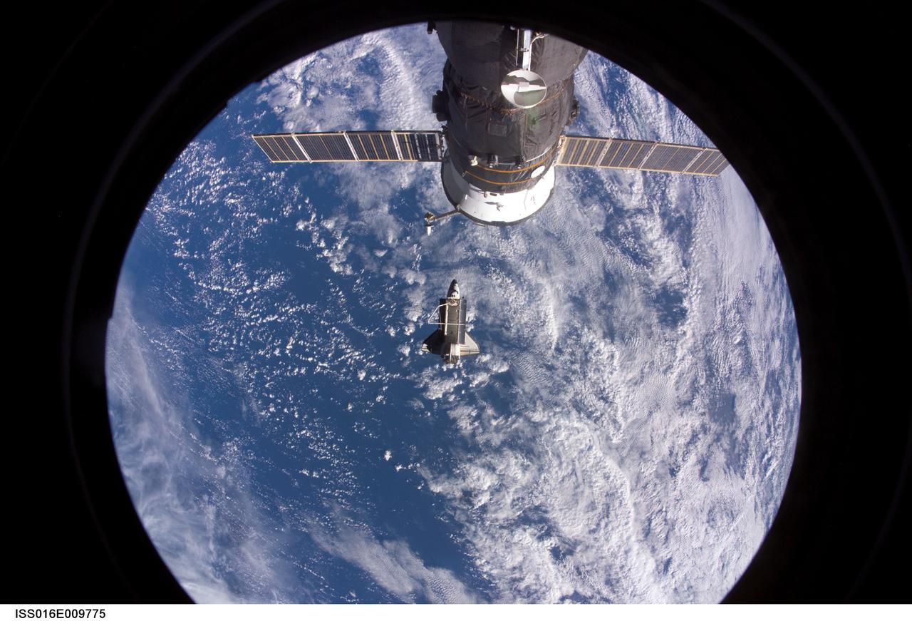 ISS016-E-009775 (5 Nov. 2007) --- Backdropped by a blue and white Earth, Space Shuttle Discovery is featured in this image photographed by an Expedition 16 crewmember after the shuttle undocked from the International Space Station. Earlier the STS-120 and Expedition 16 crews concluded 11 days of cooperative work onboard the shuttle and station. Undocking of the two spacecraft occurred at 4:32 a.m. (CST) on Nov. 5, 2007. A Russian spacecraft docked to the station is visible at top.