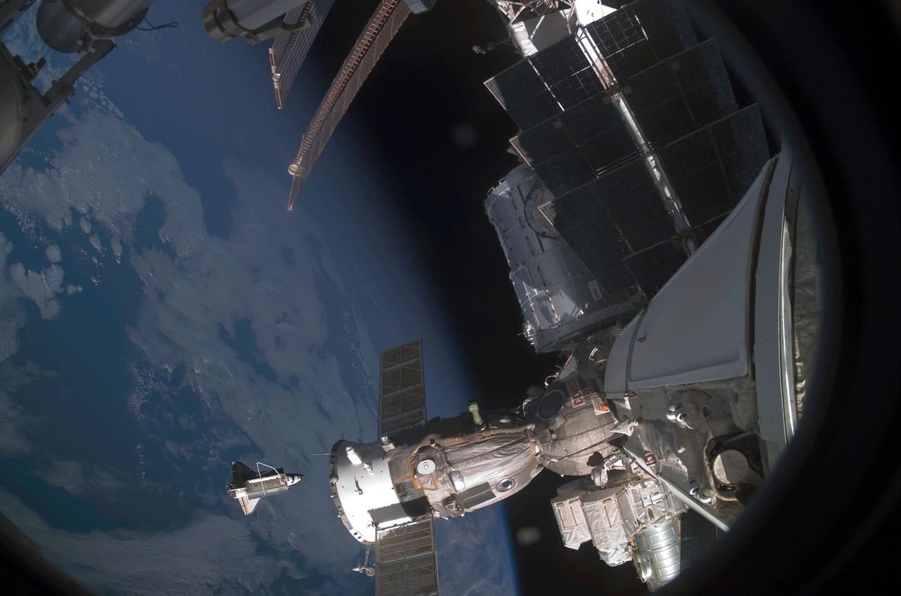 ISS016-E-009791 (5 Nov. 2007) --- Backdropped by a blue and white Earth, Space Shuttle Discovery is featured in this image photographed by an Expedition 16 crewmember after the shuttle undocked from the International Space Station. Earlier the STS-120 and Expedition 16 crews concluded 11 days of cooperative work onboard the shuttle and station. Undocking of the two spacecraft occurred at 4:32 a.m. (CST) on Nov. 5, 2007. A Soyuz spacecraft docked to the station is visible in the foreground.