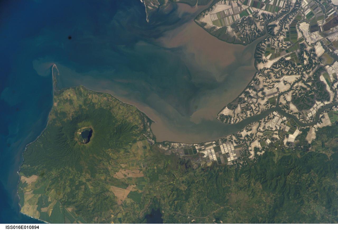 ISS016-E-010894 (17 Nov. 2007) --- Cosiguina Volcano, Nicaragua is featured in this image photographed by an Expedition 16 crewmember on the International Space Station. Three Central American countries (El Salvador, Honduras, and Nicaragua) include coastline along the Gulf of Fonseca that opens into the Pacific Ocean. The southern boundary of the Gulf is a peninsula formed by the Cosiguina volcano illustrated in this view. Cosiguina is a stratovolcano, typically tall cone-shaped structures formed by alternating layers of solidified lava and volcanic rocks (ash, pyroclastic flows, breccias) produced by explosive eruptions. The summit crater is filled with a lake (Laguna Cosiguina). The volcano last erupted in 1859, but its most famous activity occurred in 1835 when it produced the largest historical eruption in Nicaragua. Ash from the 1835 eruption has been found in Mexico, Costa Rica, and Jamaica. The volcano has been quiet since 1859, only an instant in terms of geological time. An earthquake swarm was measured near Cosiguina in 2002, indicating that tectonic forces are still active in the region although the volcano is somewhat isolated from the line of more recently active Central American volcanoes to the northwest and southeast. Intermittently observed gas bubbles in Laguna Cosiguina, and a hot spring along the eastern flank of the volcano are the only indicators of hydrothermal activity at the volcano. The fairly uniform vegetation cover (green) on the volcano's sides also attest to a general lack of gas emissions or "hot spots" on the 872 meter high cone, according to NASA scientists who study the photos downlinked from the orbital outpost.