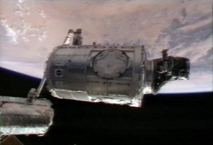 ISS016-E-011442 (14 Nov. 2007) --- In the grasp of the International Space Station's Canadarm2, the Harmony node with the Pressurized Mating Adapter (PMA-2) attached is moved from its temporary location on the left side of the Unity node to its new home on the front of the Destiny laboratory. Astronaut Daniel Tani, Expedition 16 flight engineer, operated the station's robotic arm from inside Destiny. The blackness of space and Earth's horizon provide the backdrop for the view, which was taken from NASA television.