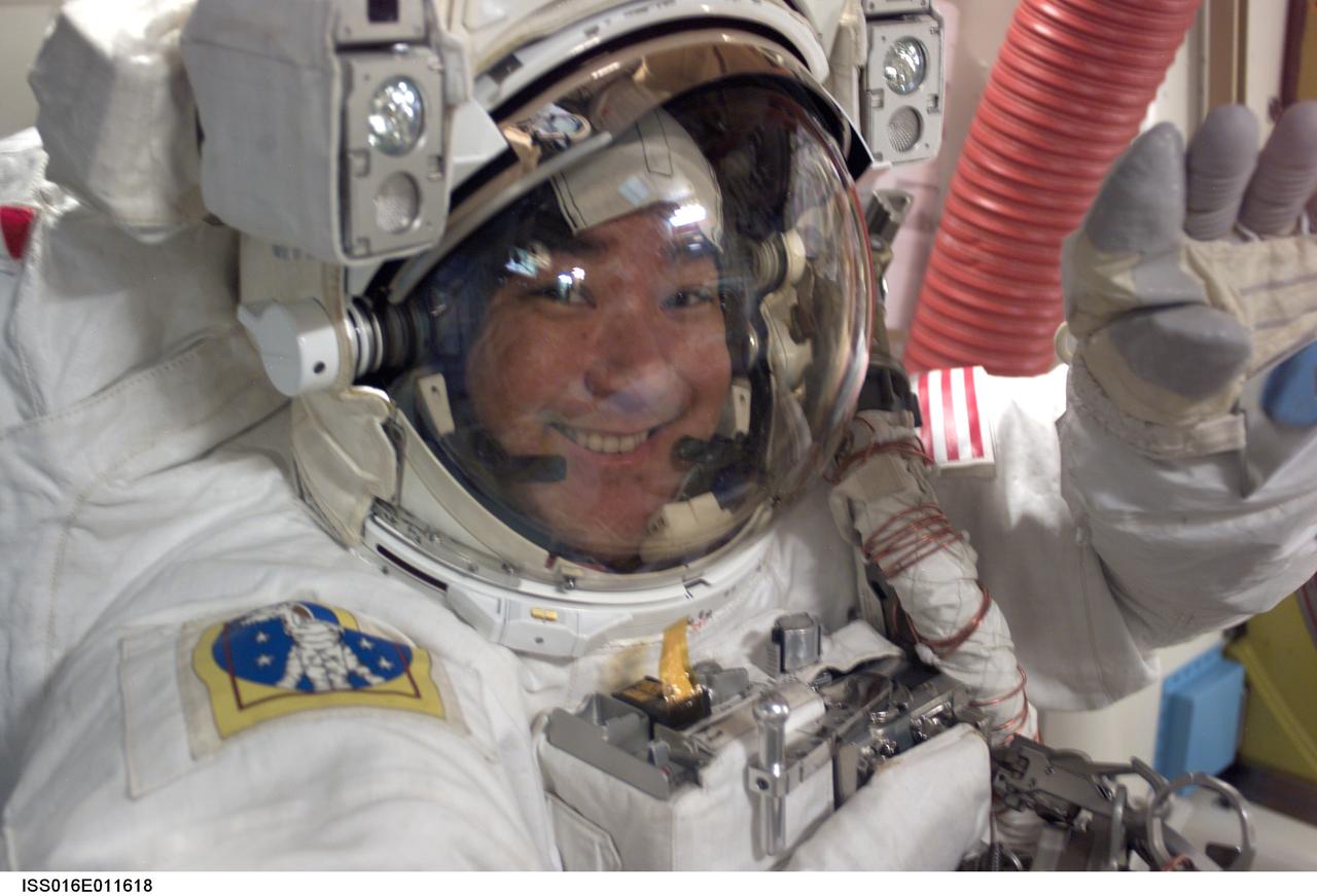 ISS016-E-011618 (20 Nov. 2007) --- Astronaut Daniel Tani, Expedition 16 flight engineer, prepares to exit the airlock prior to a Nov. 20 spacewalk to perform work on the International Space Station. Astronaut Peggy Whitson (out of frame), Expedition 16 commander, also participated in the spacewalk.