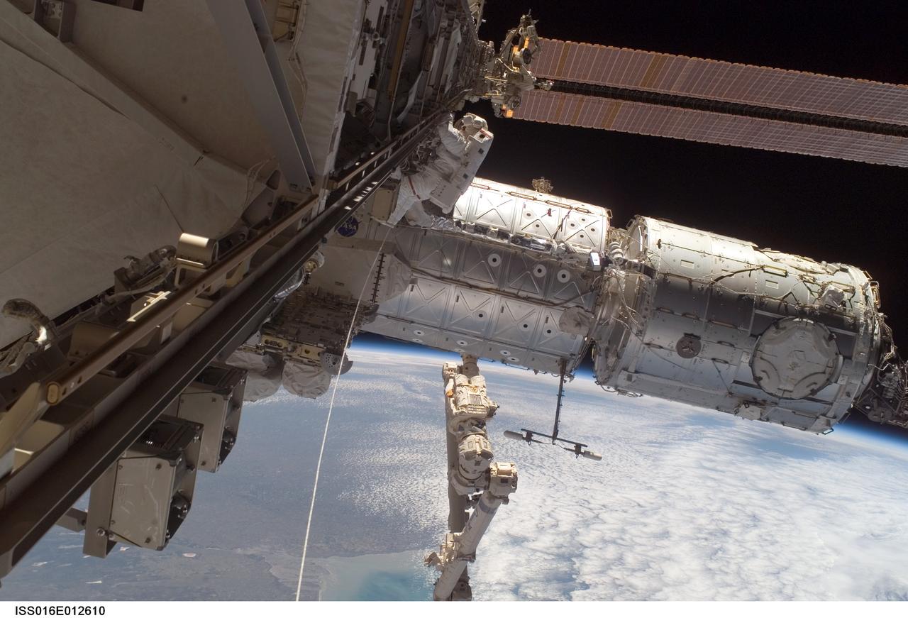 ISS016-E-012610 (24 Nov. 2007) --- Astronaut Peggy Whitson, Expedition 16 commander, participates in a session of extravehicular activity (EVA) as construction continues on the International Space Station. During the 7-hour, 4-minute spacewalk Whitson and astronaut Daniel Tani (out of frame), flight engineer, continued the external outfitting of the Harmony node in its new position in front of the Destiny laboratory. The blackness of space and Earth's horizon provide the backdrop for the scene.