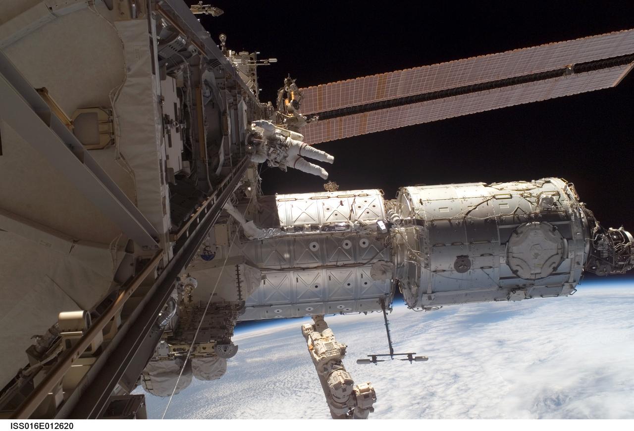 ISS016-E-012620 (24 Nov. 2007) --- Astronaut Peggy Whitson, Expedition 16 commander, participates in a session of extravehicular activity (EVA) as construction continues on the International Space Station. During the 7-hour, 4-minute spacewalk Whitson and astronaut Daniel Tani (out of frame), flight engineer, continued the external outfitting of the Harmony node in its new position in front of the Destiny laboratory. The blackness of space and Earth's horizon provide the backdrop for the scene.