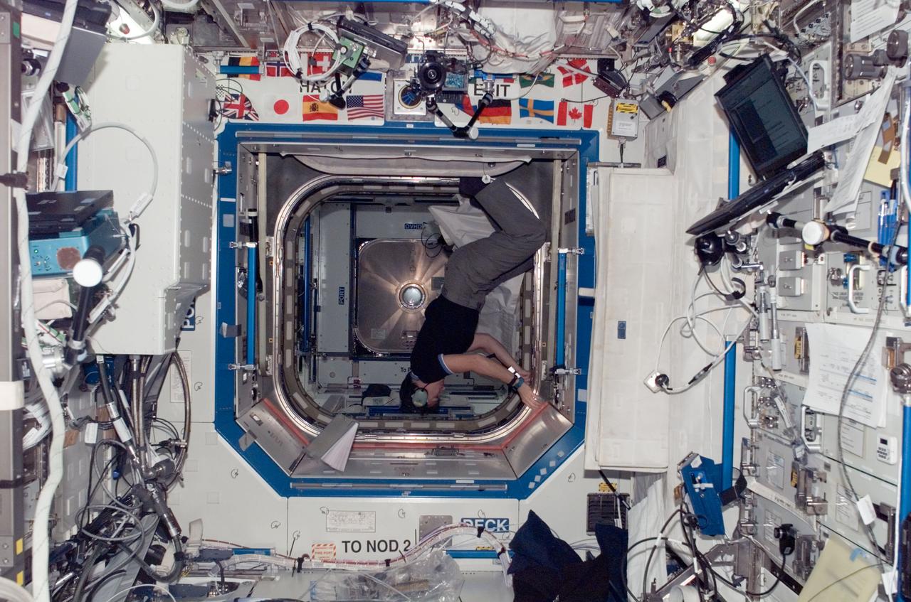ISS016-E-013173 (28 Nov. 2007) --- Astronaut Peggy Whitson, Expedition 16 commander, works in the vestibule between the Harmony node and Destiny laboratory of the International Space Station.
