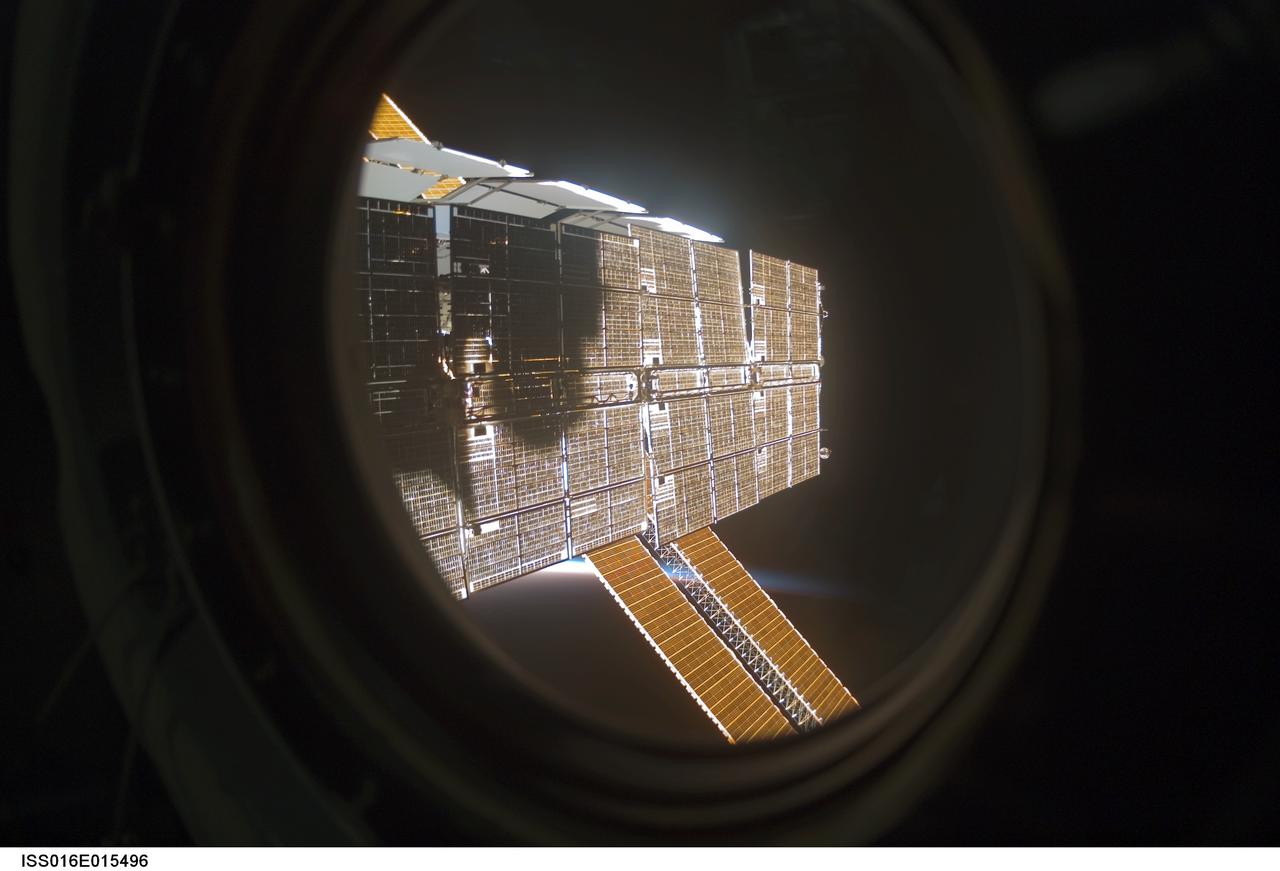 ISS016-E-015496 (9 Dec. 2007) --- Solar array panels of the International Space Station are featured in this image photographed by an Expedition 16 crewmember (out of frame) from a window on the station. The blackness of space and airglow of Earth's horizon provide the backdrop for the scene.