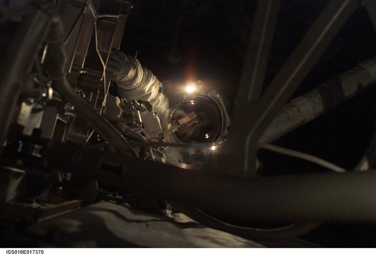 ISS016-E-017370 (18 Dec. 2007) --- Astronaut Peggy A. Whitson, Expedition 16 commander, participates in a session of extravehicular activity (EVA). During the 6-hour, 56-minute spacewalk, Whitson and astronaut Daniel Tani (out of frame), flight engineer, looked for the cause of partial loss of electrical power to one of the International Space Station's two Beta Gimbal Assemblies (BGA) for starboard solar wings and examined damage to the starboard Solar Alpha Rotary Joint (SARJ). The spacewalk was the 100th for the construction and maintenance of the station.