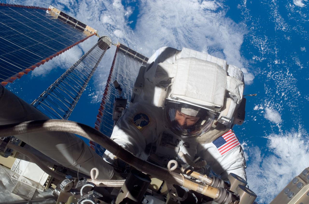 ISS016-E-017499 (18 Dec. 2007) --- Astronaut Peggy A. Whitson, Expedition 16 commander, participates in a session of extravehicular activity (EVA). During the 6-hour, 56-minute spacewalk, Whitson and astronaut Daniel Tani (out of frame), flight engineer, looked for the cause of partial loss of electrical power to one of the International Space Station's two Beta Gimbal Assemblies (BGA) for starboard solar wings and examined damage to the starboard Solar Alpha Rotary Joint (SARJ). The spacewalk was the 100th for the construction and maintenance of the station. A blue and white Earth provides the background for the scene.