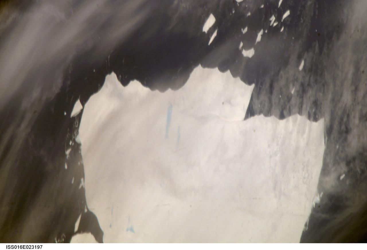 ISS016-E-023197 (15 Jan. 2008) --- A portion of Mega-iceberg A53a in the South Atlantic Ocean is featured in this image photographed by an Expedition 16 crewmember on the International Space Station. At the time this image was taken in mid-January 2008, the entire iceberg measured close to 50 kilometers x 22 kilometers, about seven times the area of Manhattan Island. Icebergs of the Southern Atlantic Ocean contain rock material from Antarctica, eroded by the moving ice and also as wind-borne dust from deserts in Africa, South America and Australia. According to NASA scientists, the finest powdery rock material acts as nutrient for sea organisms. As icebergs melt, the surrounding seawater is enriched. The area of enrichment is significantly enlarged when a mega-iceberg disintegrates into many small pieces.