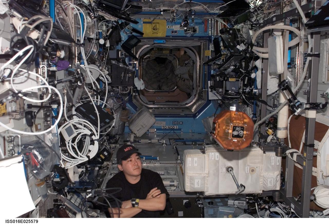 ISS016-E-025579 (27 Jan. 2008) --- Astronaut Daniel Tani, Expedition 16 flight engineer, does a check of the Synchronized Position Hold, Engage, Reorient, Experimental Satellites (SPHERES) Beacon/Beacon Tester in the Destiny laboratory of the International Space Station.